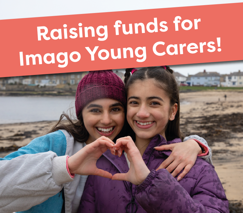 two girls making a heart shape with their hands. Banner that says raising funds for Imago Young Carers.